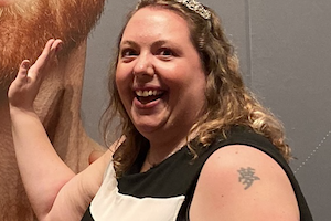 Rebecca touching a photograph of her bearded idol.