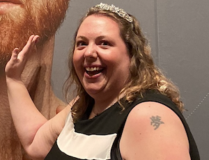 Rebecca touching a photograph of her bearded idol.