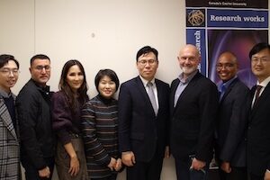 Group of signatories pose in a line
