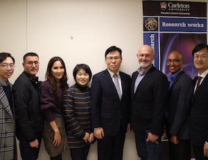 Group of signatories pose in a line