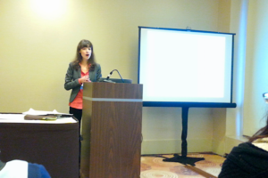 Olga standing at a podium