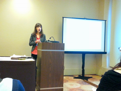 Olga standing at a podium