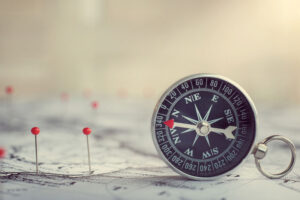 Retro compass on ancient map background. Travel geography navigation concept background.