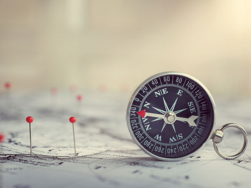 Retro compass on ancient map background. Travel geography navigation concept background.