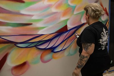 picture of Mique Michelle painting a mural