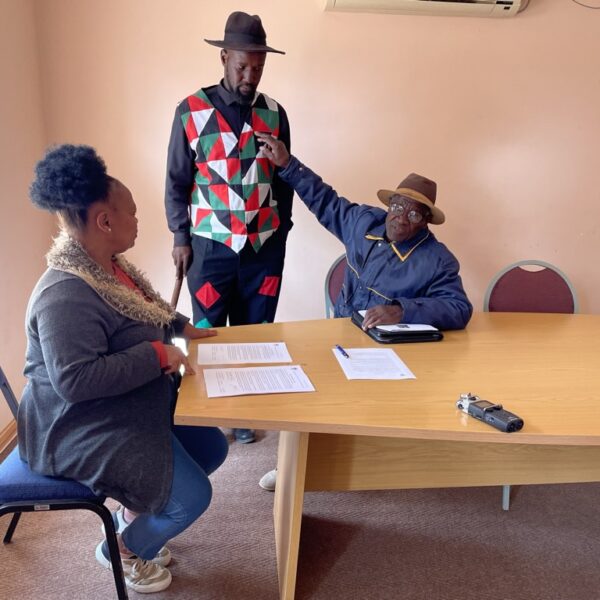 Abraham Katimba gestures at the Riemvasmaak Choir uniform.