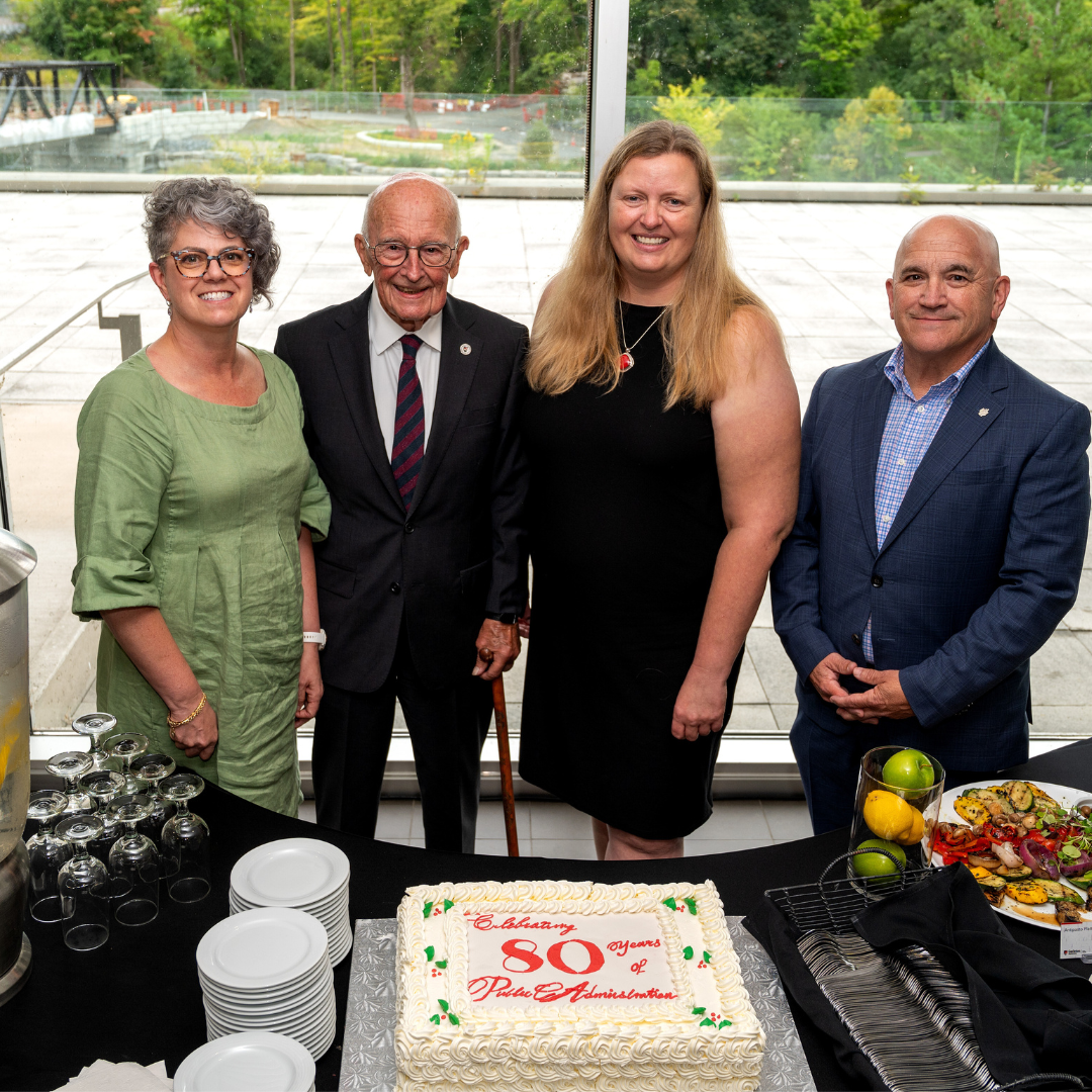 group photo by anniversary cake: Brenda O'Neill, Jos Bisset, Jennifer Stewart and Bob Masterson