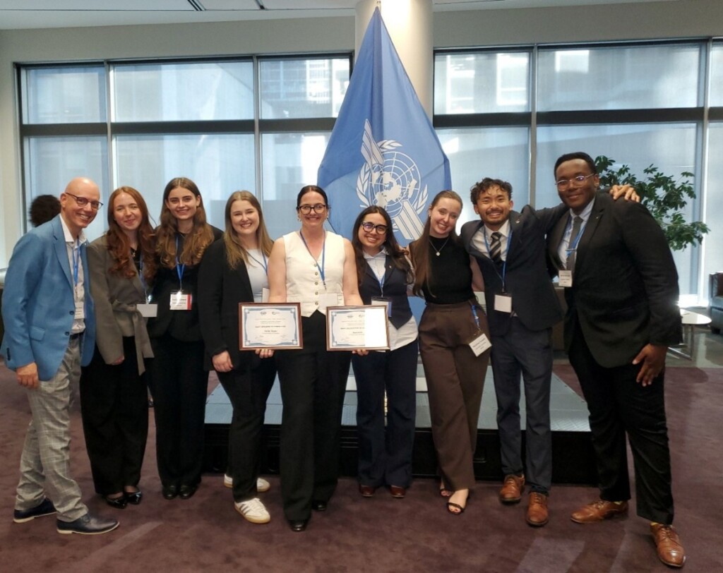 Group photo in front of ICAO flag