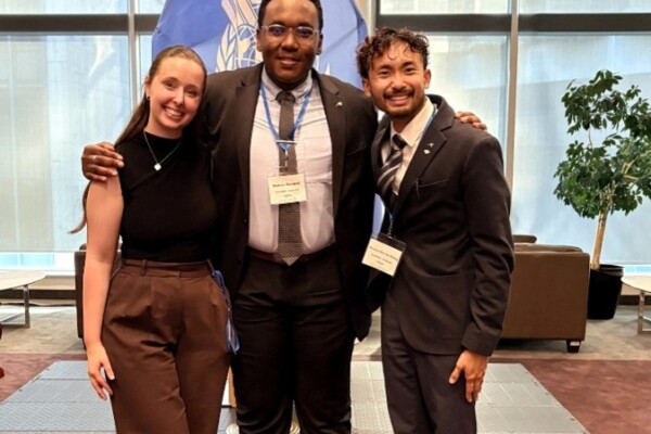 SPPA and NPSIA participants posing in front of ICAO flag