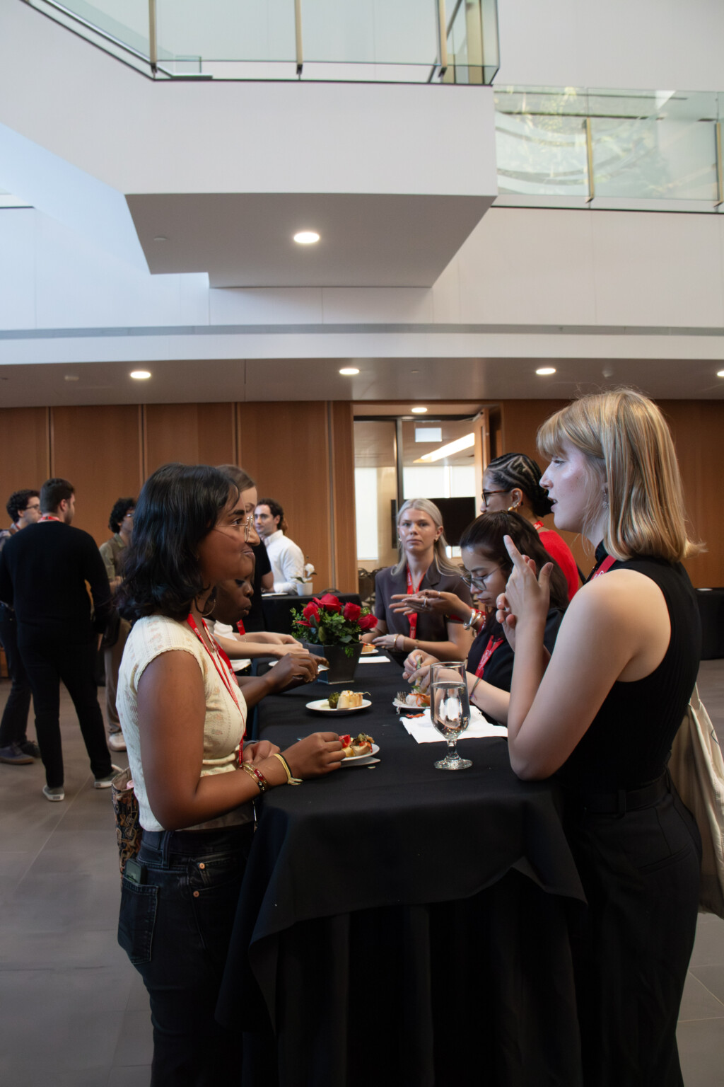 Guests gather around a high-top table in Richcraft Hall Atrium during the Alumni Reception.