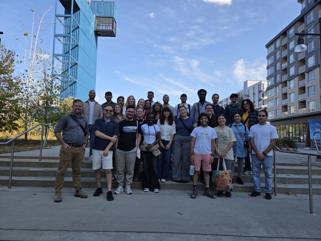 A group of Carleton students smiling in front of the the Zibi Innovative District Energy System