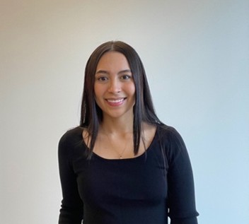 Speaker in black top against white background