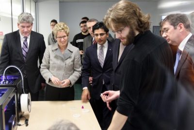 Provincial and municipal delegates look at the Discovery Centre's 3D printers