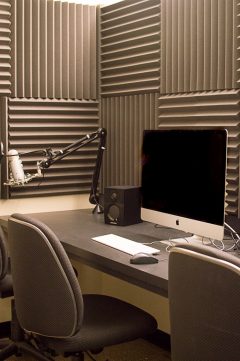 Inside the edit suites - a computer, microphone and acoustically treated walls