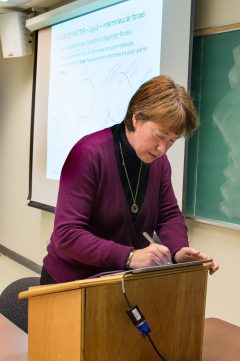 Pam Wolff uses a stylus pen to write on a tablet
