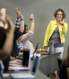 Professor Peggy Hartwick calls on students in class who have their hands raised