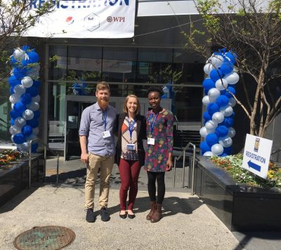 Travis, Vicky and Nana stand outside the registration area at the conference