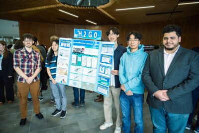 Carleton students pose with their poster for the H2GO project.