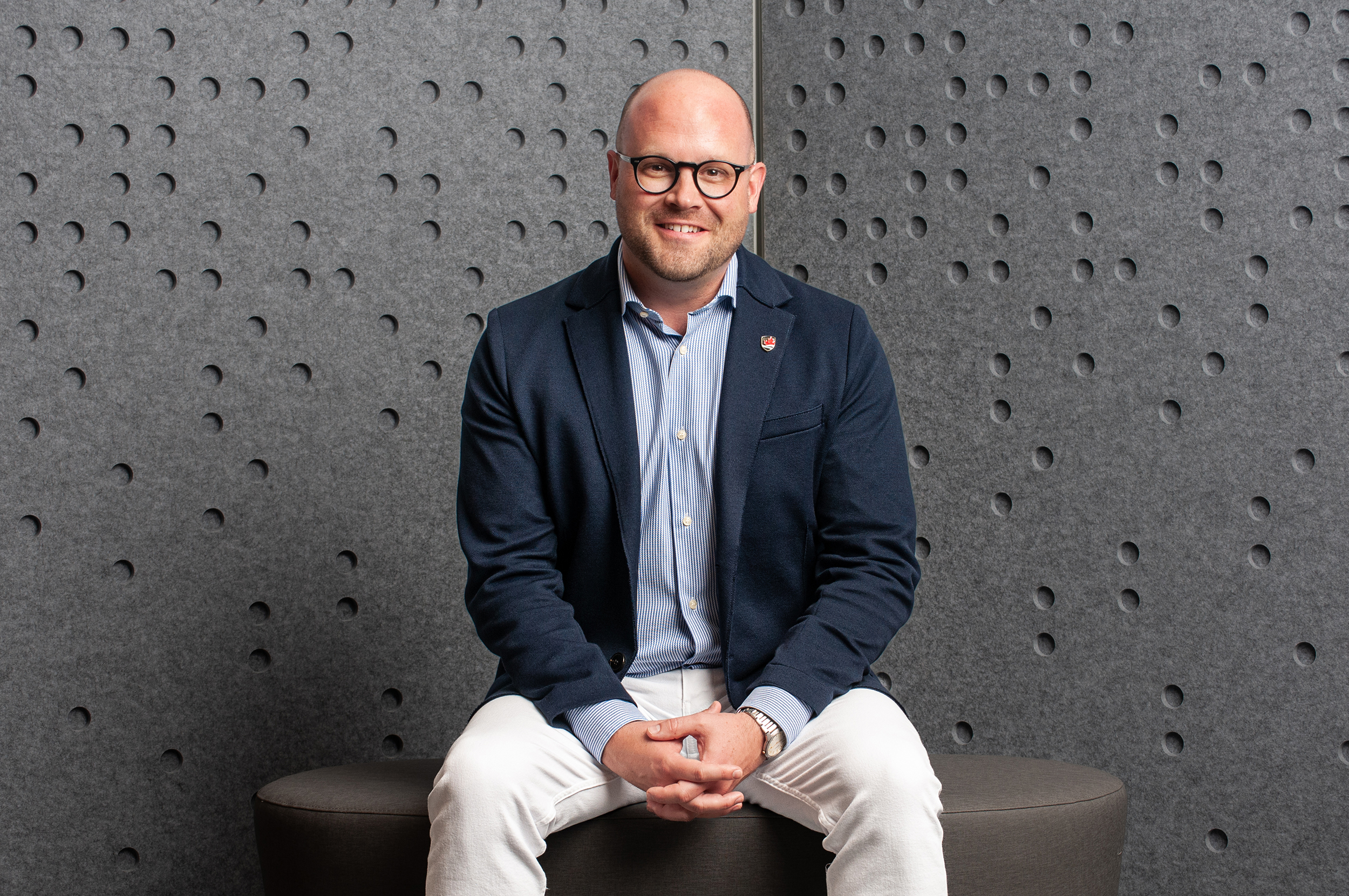 David Hornsby seated in front of a grey background
