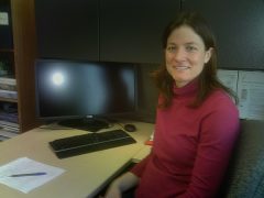 Emily Heath sits at her desk