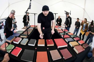 Prof. Jesse Stewart plays a bibliophone—a xylophone made out of hardcover books