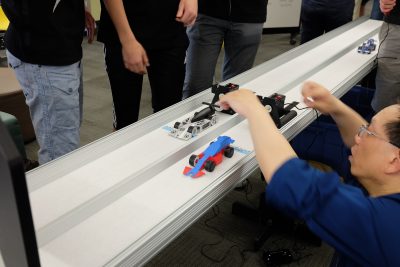 Two 3D printed cars on a track