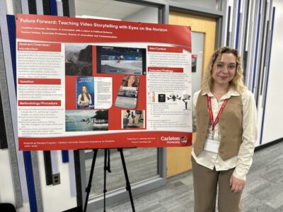 Josefine Lukaszek stands with her project poster