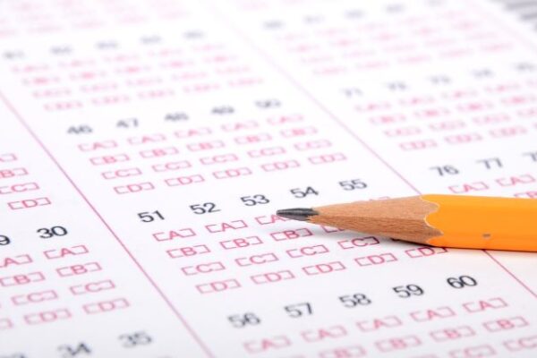 Up close of a scantron sheet with pencil on top.