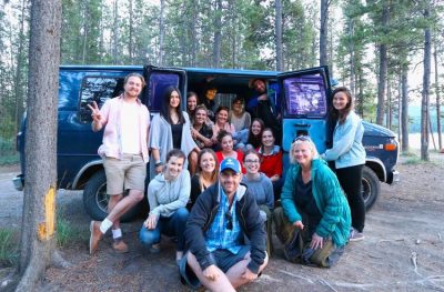 The Stories North team piles in and around a van for a group photo