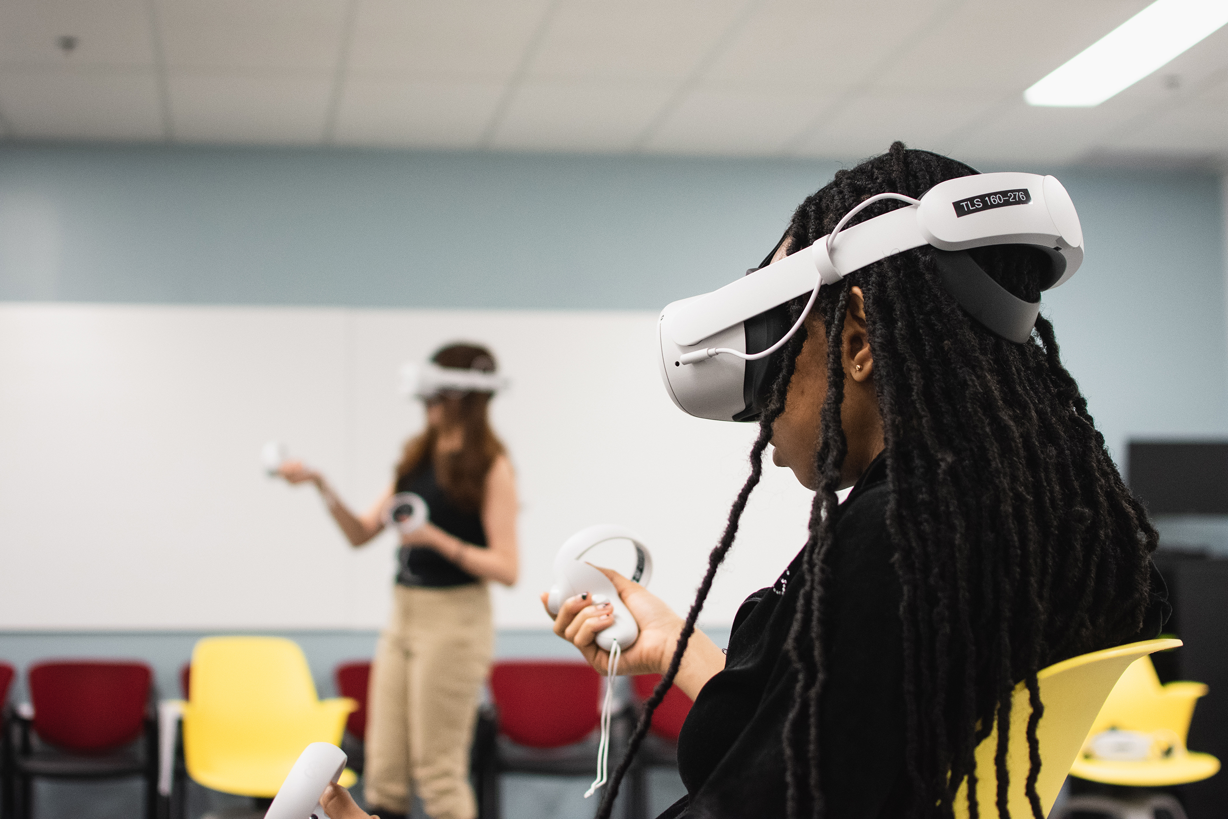 Students participating in a film screening using VR equipment