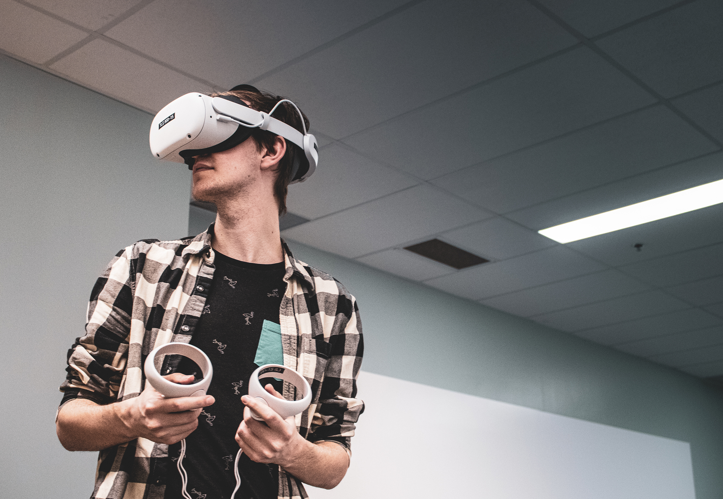 Student wearing VR goggles and controllers