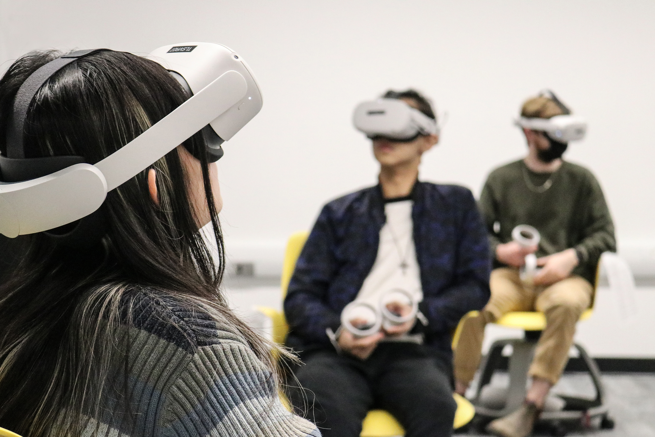 Students participating in a film screening using VR equipment