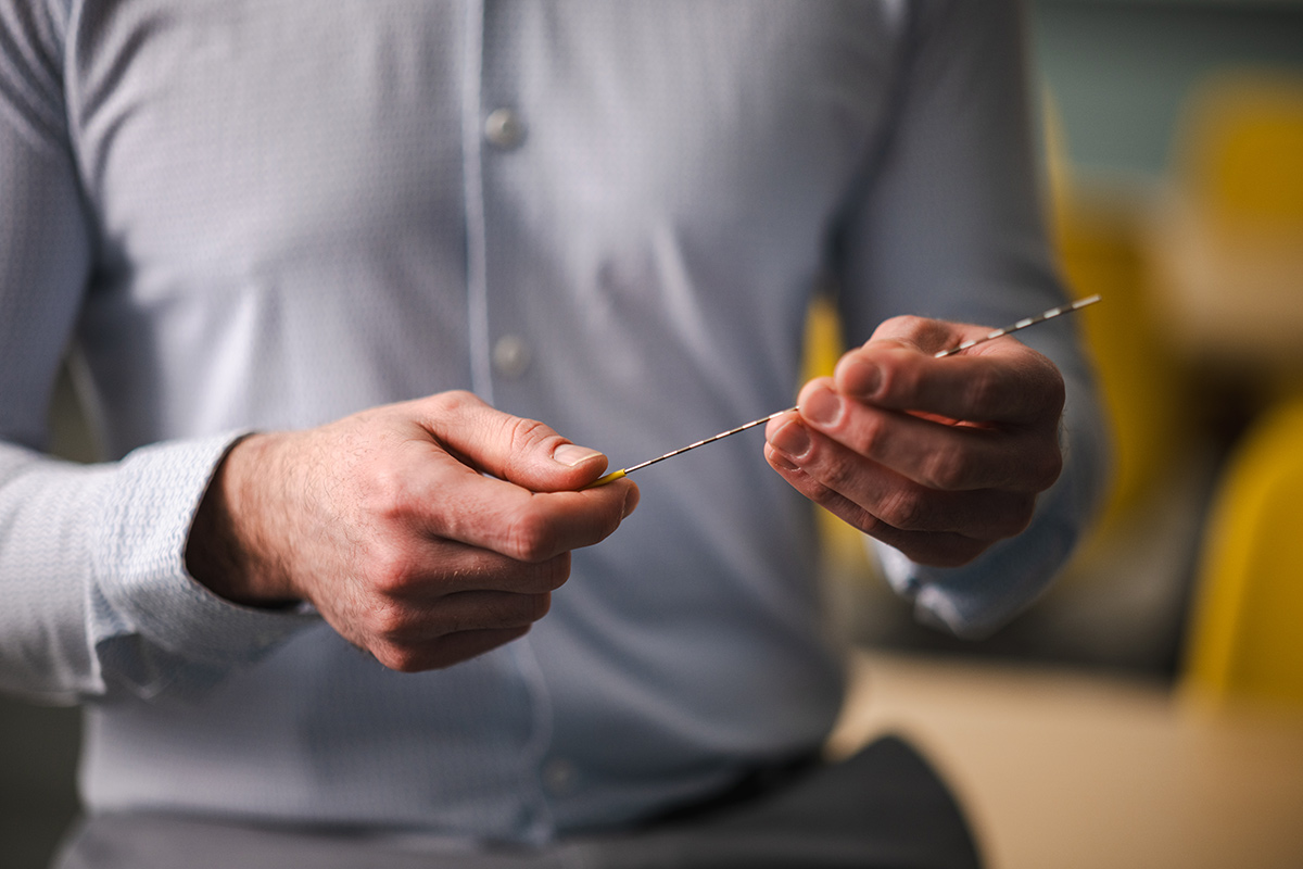 Man holding a biopsy tool used for prostate cancer detection in his hands.